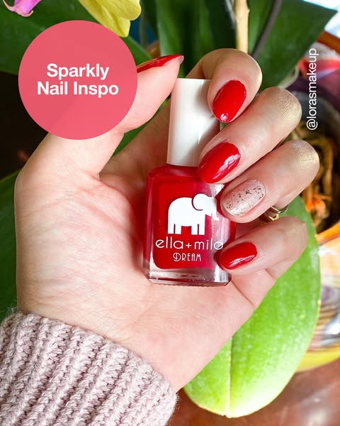 The ad features a hand holding a bottle of ella+milo Dream nail polish, with nails painted in a matching red color. A pi