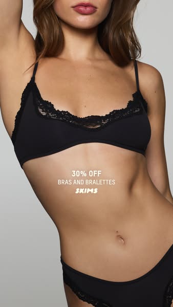This SKIMS image ad promotes a 30% off discount on bras and bralettes by showing a model wearing a black bra and underwe