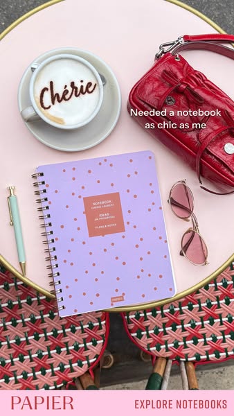 An image ad featuring a Papier notebook as a chic, personalized desk accessory. The ad features a flat lay with the note
