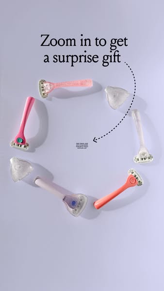 This ad features a flatlay of razors and razor head covers arranged in a circle. The ad encourages the viewer to zoom in