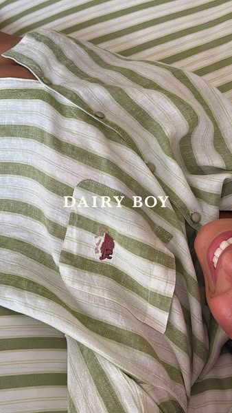 This ad features a person wearing a striped shirt. The focal point of the image is the embroidered logo on the shirt'