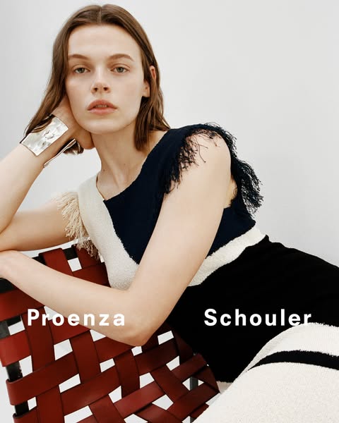 This is a studio shot promoting apparel from Proenza Schouler. A model is shown wearing a dress from the brand, with the