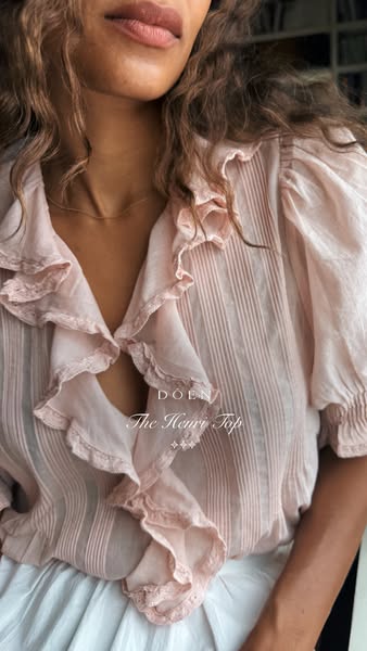 This Meta image ad for DOEN features a woman wearing The Henri Top. The image has a soft, organic aesthetic. The text ov