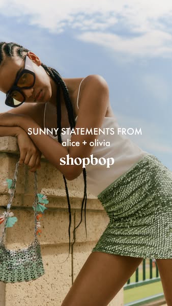 This ad features a model showcasing clothing and accessories from alice + olivia, available on Shopbop. The visual style