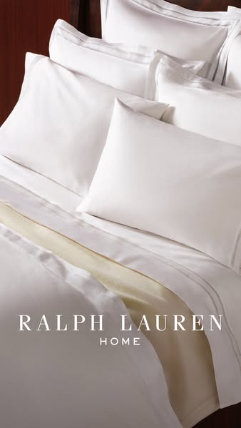 This image ad promotes Ralph Lauren Home bedding. The image showcases a bed with multiple pillows and layers of blankets