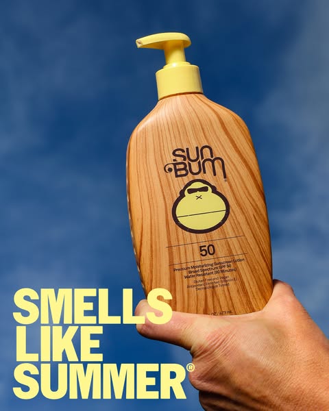 This ad features a hand holding Sun Bum sunscreen against a bright blue sky. The headline states that the product "