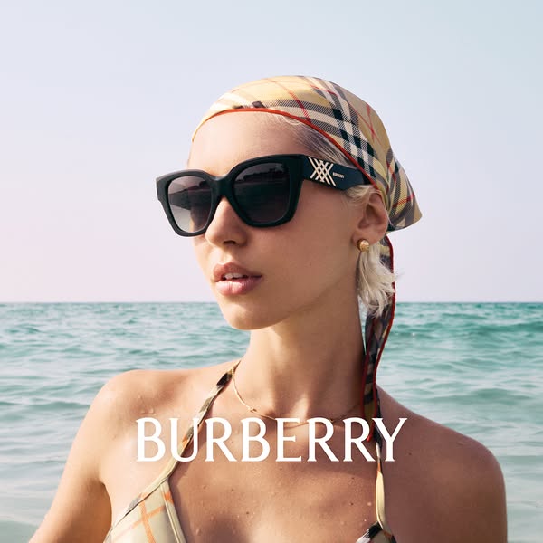 The image showcases a woman on the beach wearing a pair of Burberry sunglasses.