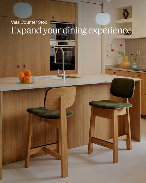 This image ad features two Vela Counter Stools in a kitchen setting. The focus is on expanding the dining experience wit