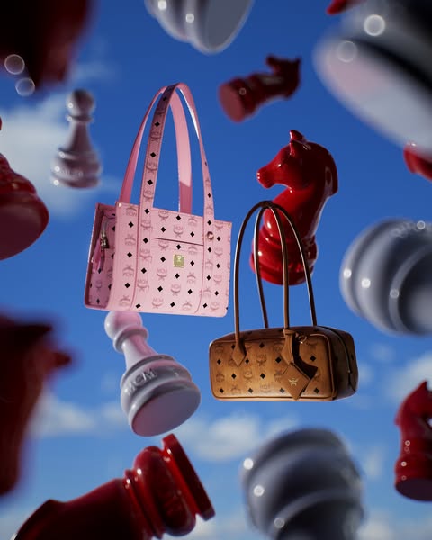 This image ad showcases two MCM handbags by displaying them with chess pieces in the sky.