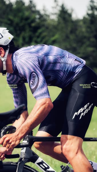 This image ad showcases apparel products from MAAP, an Australian cycling brand. The image features a person riding a bi