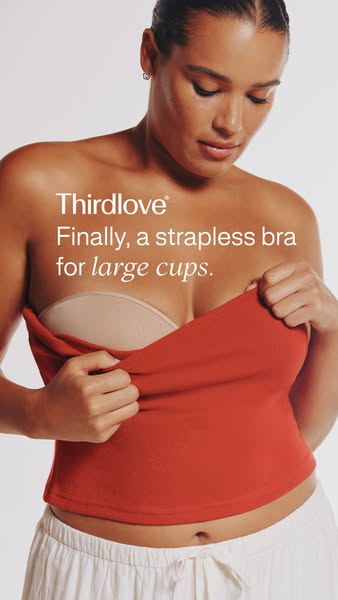The ad features a woman pulling down the top of her shirt to reveal a strapless bra. The ad headline states that the bra