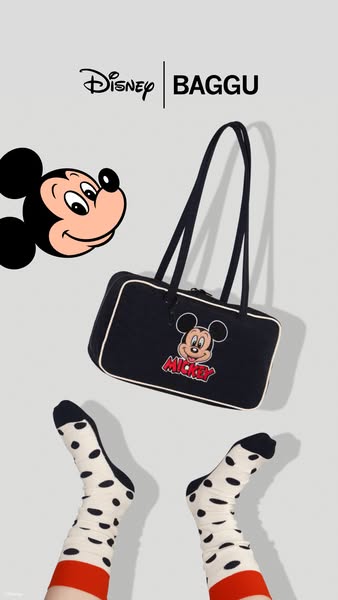 This image features a BAGGU collaboration with Disney, specifically showcasing a black rectangular purse with a white tr