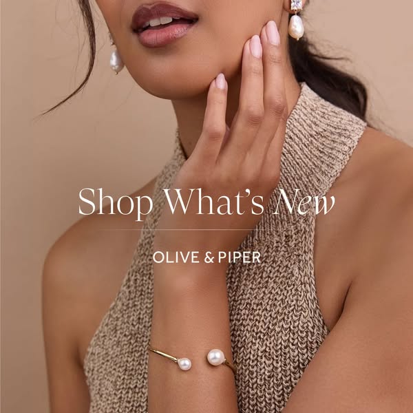 An image ad for Olive & Piper's new jewelry collection. It shows a model wearing earrings and a cuff from the ne
