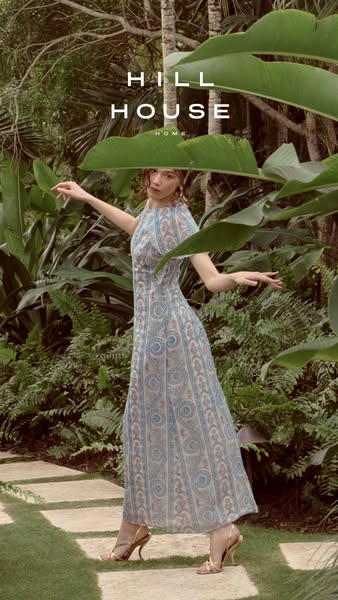 This ad showcases a woman in a garden setting, wearing a dress by Hill House Home. The visuals and setting of the ad hav