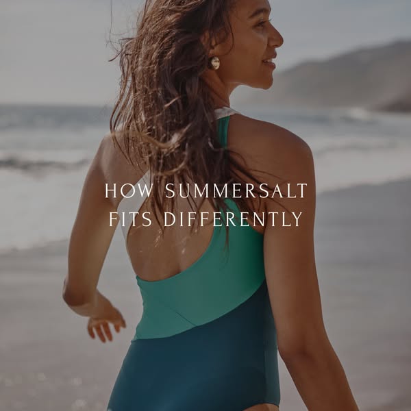 This image ad features a woman standing on a beach and looking out at the water, wearing a color-blocked Summersalt swim