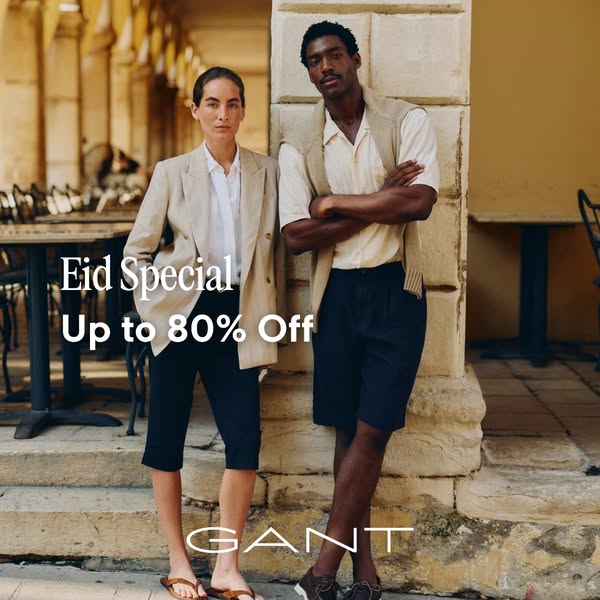 This image ad features a male and female model standing in front of an outdoor, stone-columned building. The ad promotes