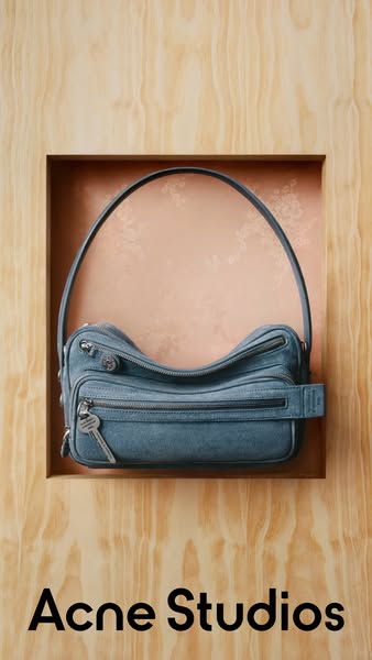 This ad features a mid-shot of an Acne Studios handbag and highlights the brand name in order to drive brand awareness.