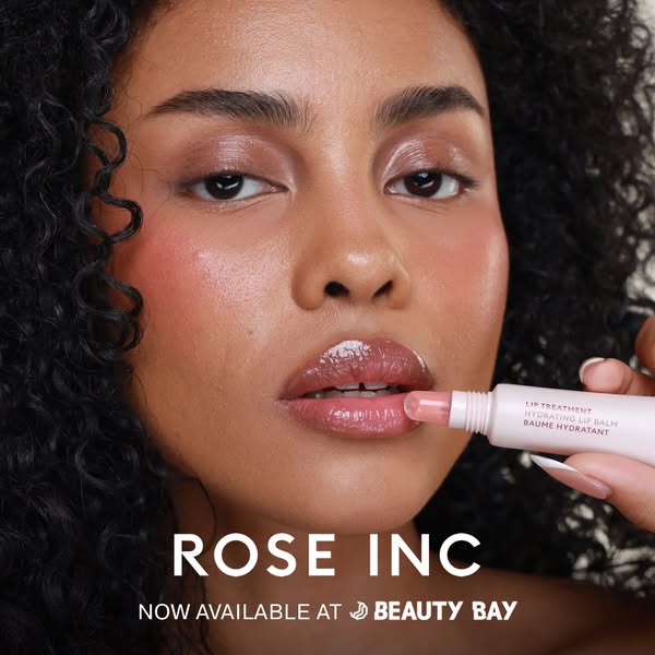 This image ad features a close-up shot of a woman applying Rose Inc Lip Treatment Hydrating Lip Balm. The ad showcases t