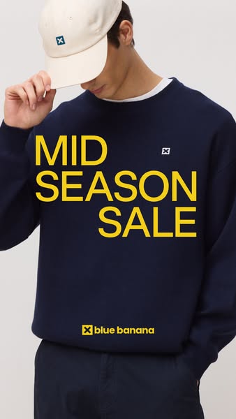 This ad features a man wearing a navy blue sweatshirt and hat from Blue Banana, advertising a mid-season sale.