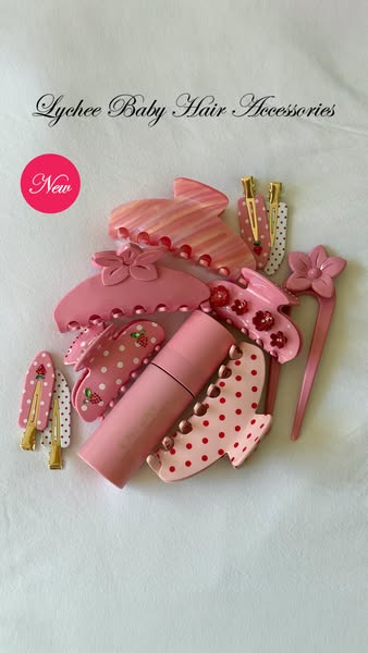 This image ad showcases a collection of hair accessories in various shades of pink, arranged around a solid pink tube. T