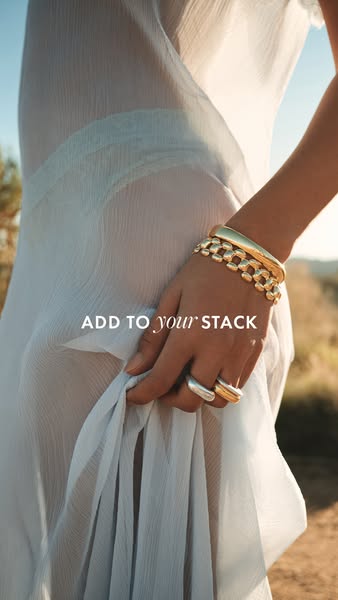 This ad showcases a variety of rings and bracelets in gold and silver while promoting the concept of curating jewelry st