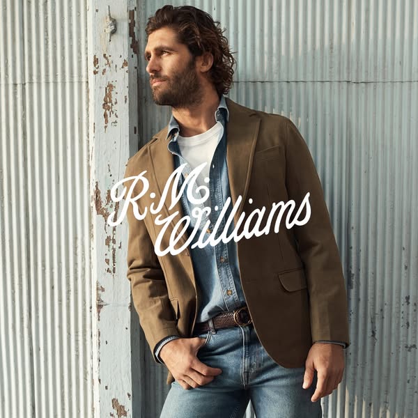 This image ad features a man wearing R.M. Williams clothing in a stylish outdoor setting. The ad aims to showcase the br