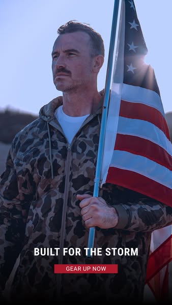 This ad features a man holding an American flag while wearing a camouflage jacket. The ad promotes the jacket as being &