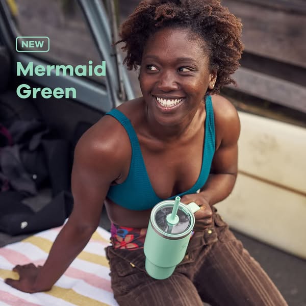An ad featuring a woman holding a tumbler, highlighting the new 'Mermaid Green' color, set against a backdrop su