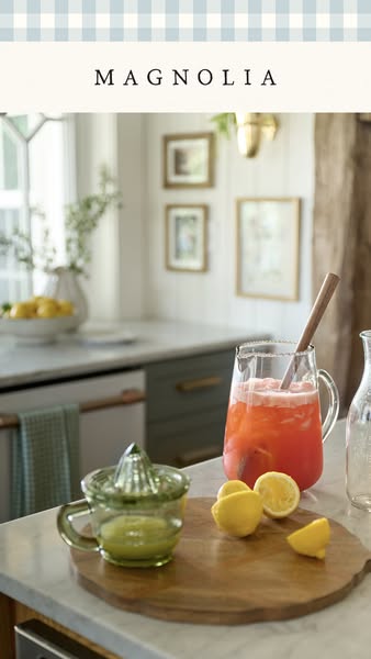 This ad for Magnolia showcases a vibrant drink with lemons on a wooden cutting board and a vintage-style juicer.