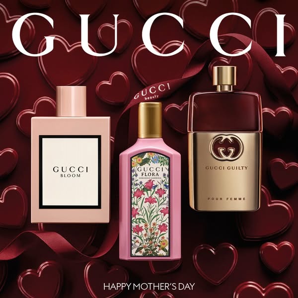 An image ad promoting a selection of Gucci perfumes for Mother's Day, set against a backdrop of hearts and ribbons, 