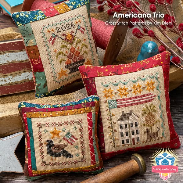 This image ad features three decorative cross-stitch pillows. Each pillow has a vintage Americana theme, with designs fe