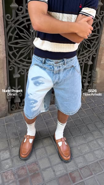 This ad features a person wearing Nude Project denim shorts with a graphic print of a face on the front. The shorts are 