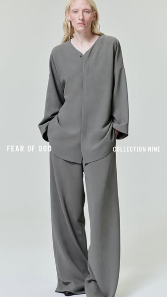This ad features a product shot of a female model wearing a grey two-piece outfit consisting of a long sleeve shirt and 