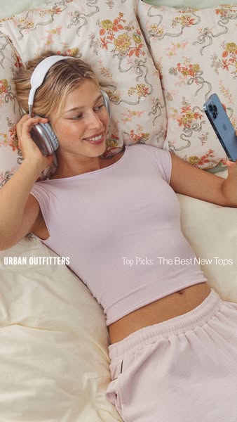This ad is promoting a new collection of tops at Urban Outfitters, featuring a woman wearing a top from the brand while 