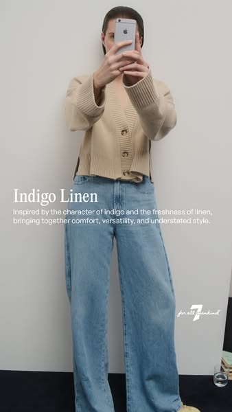 This ad features a woman taking a picture of herself wearing an outfit by 7 for all mankind, including a beige cardigan 