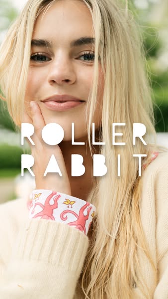 This ad features a close-up of a woman with blonde hair wearing a sweater with Roller Rabbit branded cuffs. The ad is li