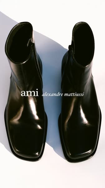This ad is a product showcase for a pair of AMI Alexandre Mattiussi black boots.