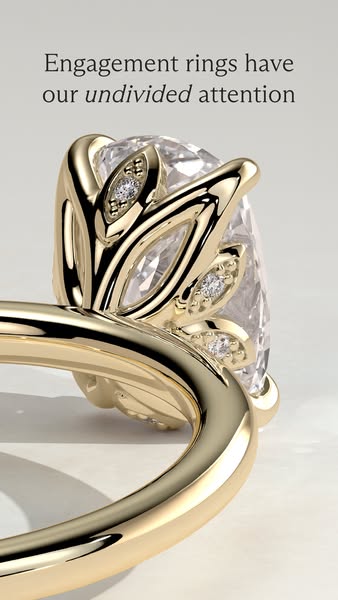 This image ad showcases a close-up view of a gold engagement ring, emphasizing its intricate floral design and sparkling