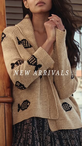 This image ad showcases a beige knitted cardigan with a pattern of black fish across the front and sleeves. The focal po