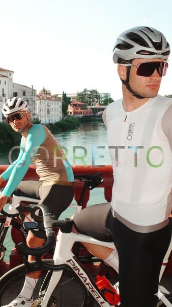 This ad showcases two cyclists wearing Corretto cycling apparel while riding their bikes near a body of water. The ad fo