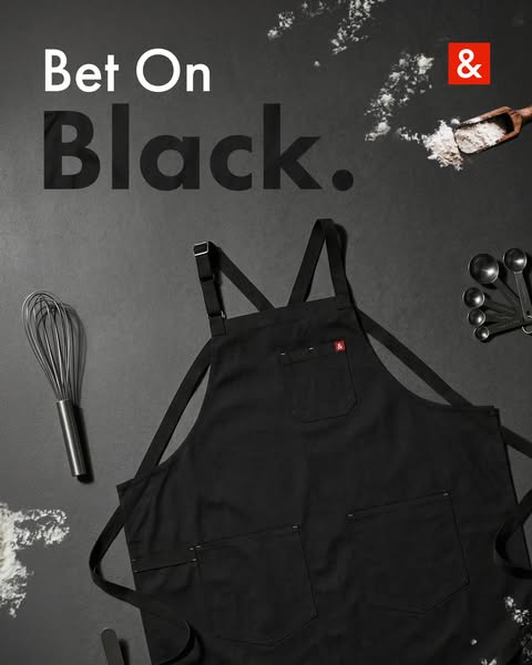 This ad features a black apron against a black background, with flour and cooking utensils as props. The headline "