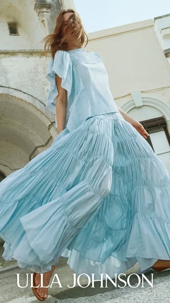 This ad showcases Ulla Johnson's clothing. The ad displays a light-blue, two-piece skirt set against a light exterio
