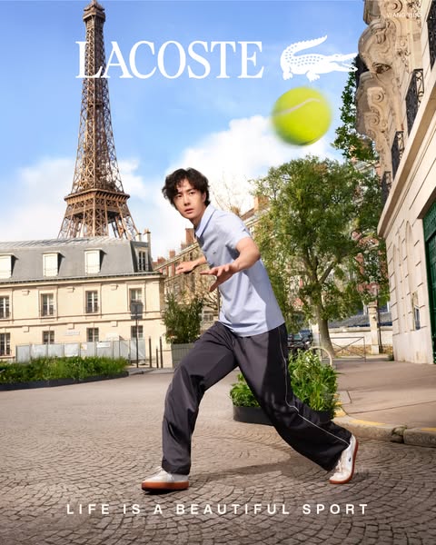This image ad features an image of a man standing in front of the Eiffel Tower, wearing Lacoste apparel. The ad promotes