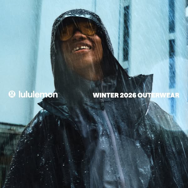 This Lululemon image ad features a Black man standing in the rain while wearing a Winter 2026 Outerwear jacket and smili