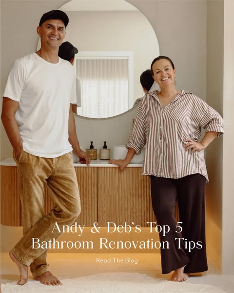 A married couple stands in their newly renovated bathroom, recommending their top five tips for a bathroom renovation. T