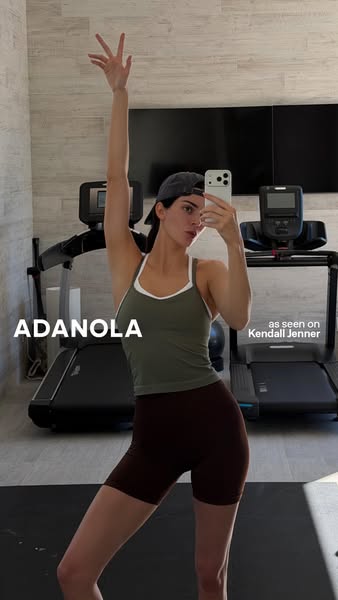 This image ad showcases an athletic outfit from ADANOLA worn by Kendall Jenner. The ad presents a casual, in-home settin