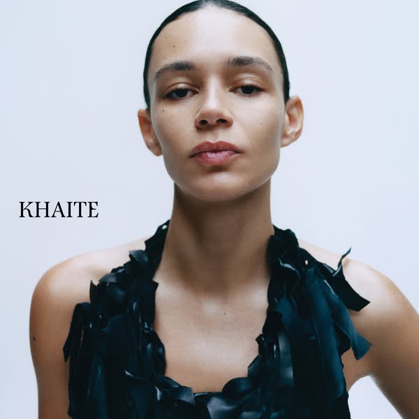 This ad features a close-up headshot of a woman wearing a Khaite dress, with the brand name displayed prominently on the