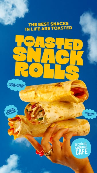 An image ad for Tropical Smoothie Cafe featuring a stack of toasted snack rolls held in a hand, against a blue sky backd