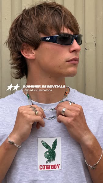 A close-up shot of a person wearing jewelry and sunglasses. The ad highlights the items as summer essentials crafted in 