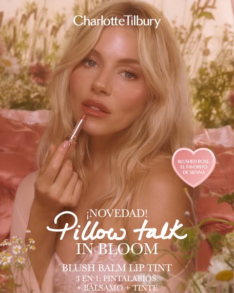 An ad for Charlotte Tilbury's Pillow Talk In Bloom blush balm lip tint featuring a fair-skinned blonde model applyin